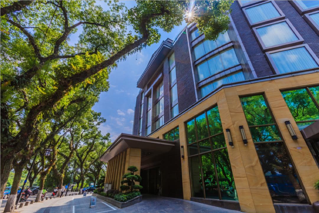 Tree-lined street entrance of Jolie Vue Boutique Hotel in central Guilin