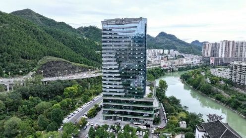 Tongren National Guesthouse tower rising above the river