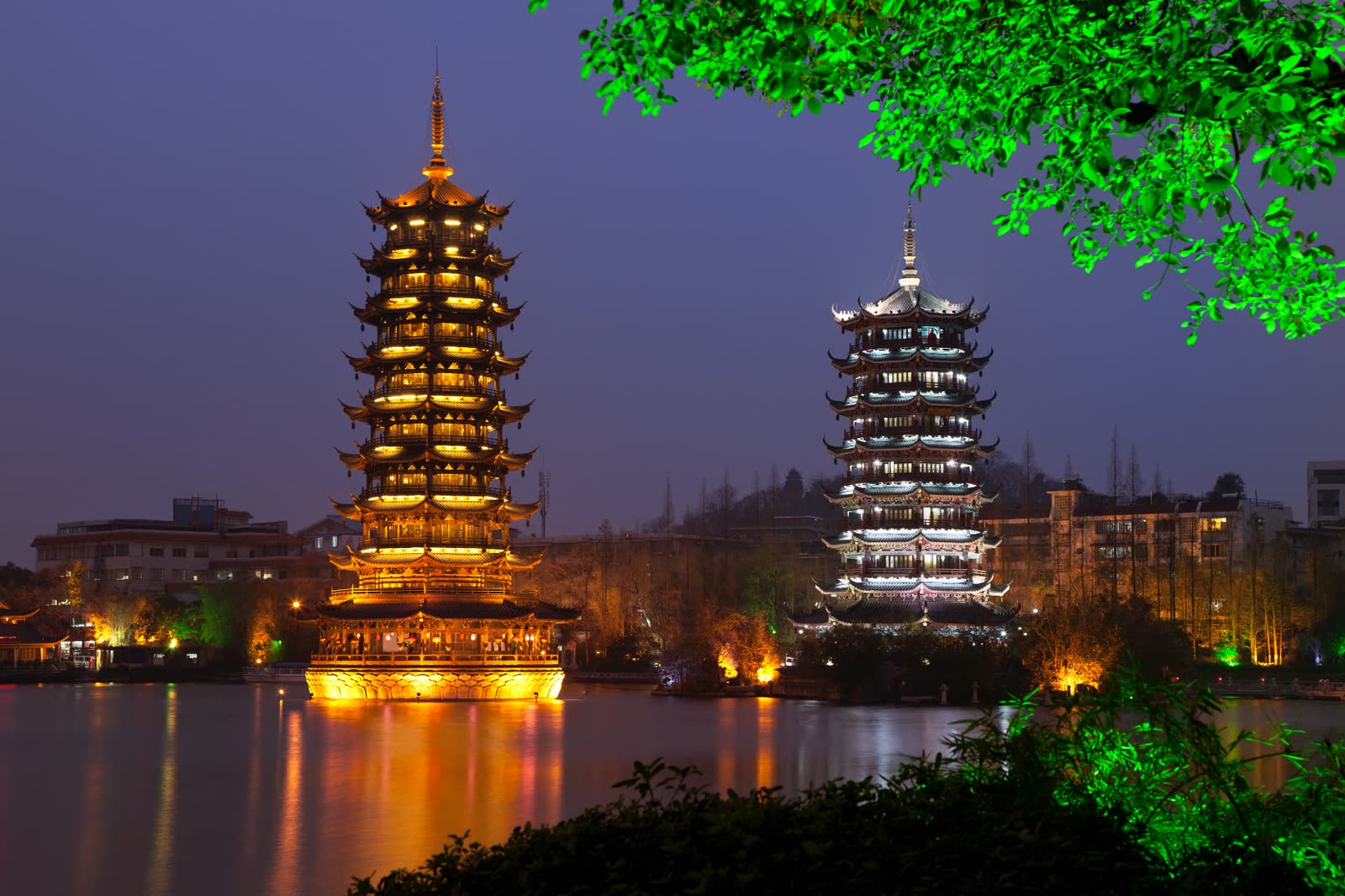 Sun and Moon Pagodas reflected on Banyan Lake in Guilin at night
