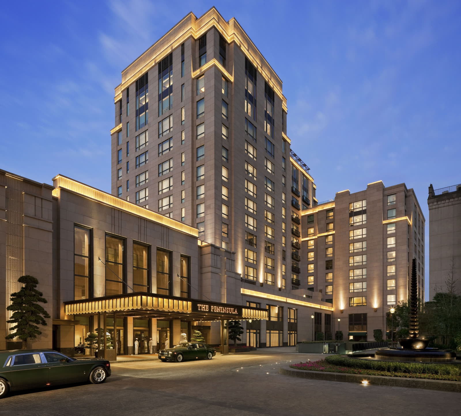Art Deco facade and entrance of The Peninsula Shanghai at dusk