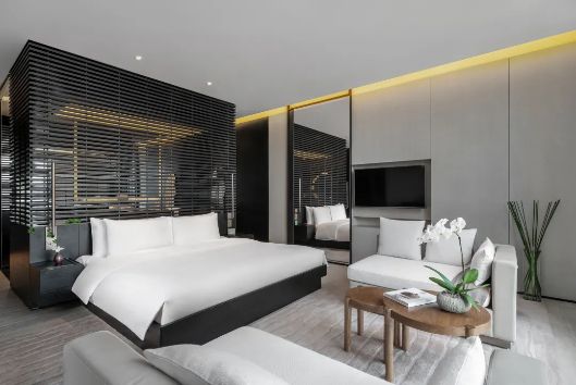 Bedroom suite with dark timber screen at The Upper House, Chengdu