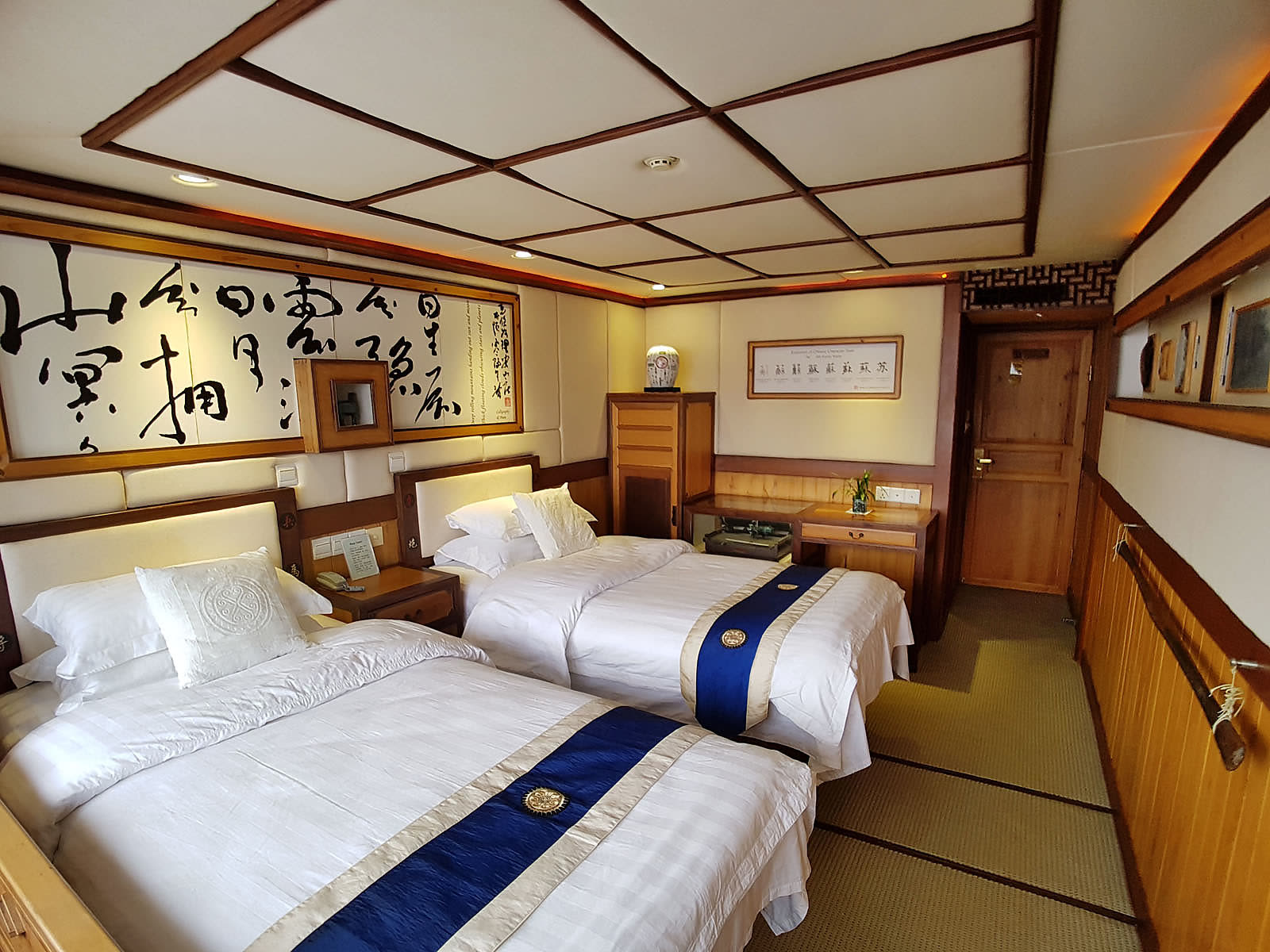Twin room at Li An Lodge with Chinese calligraphy panels and timber joinery