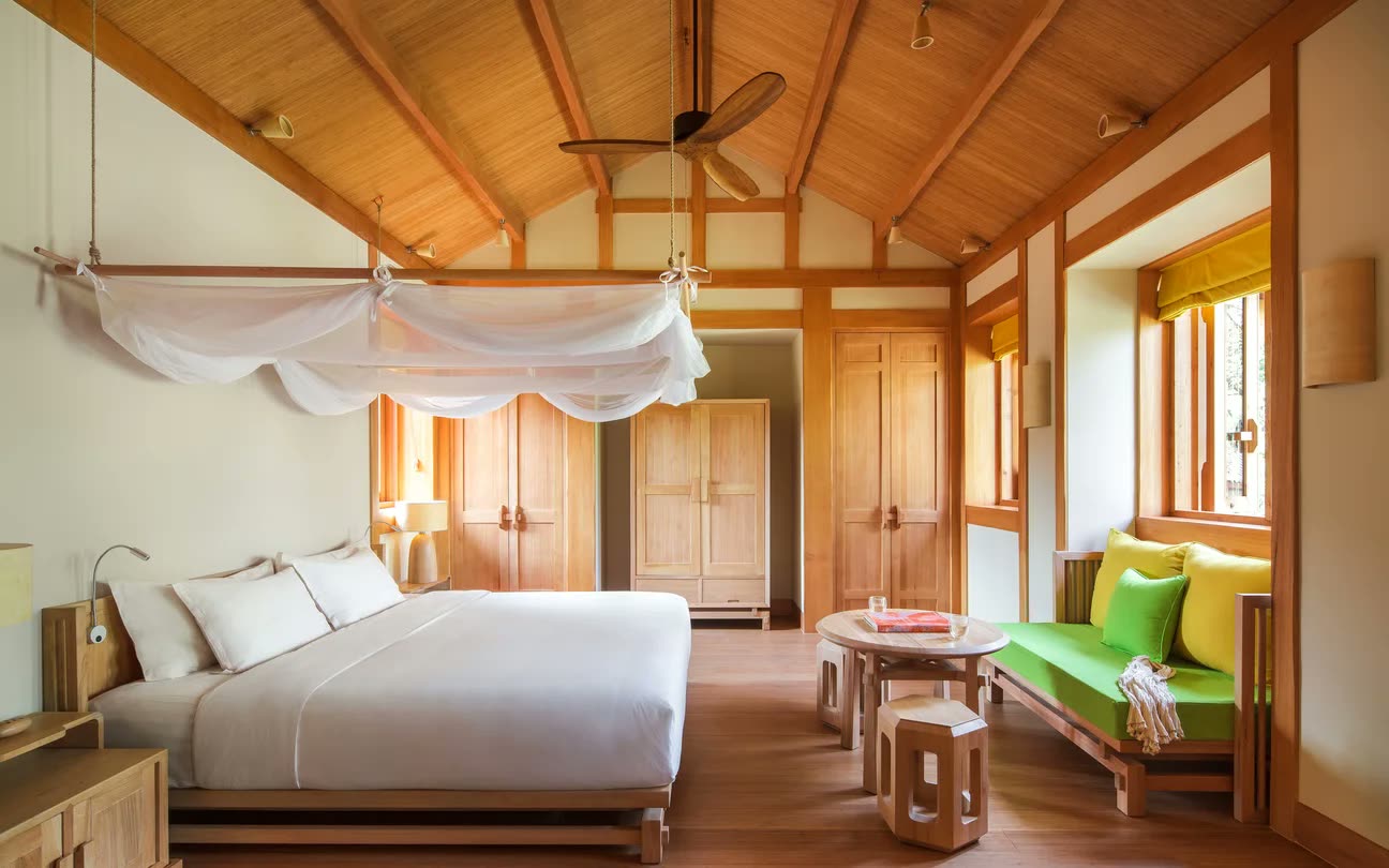 Six Senses Suite with canopied bed and vaulted timber ceiling