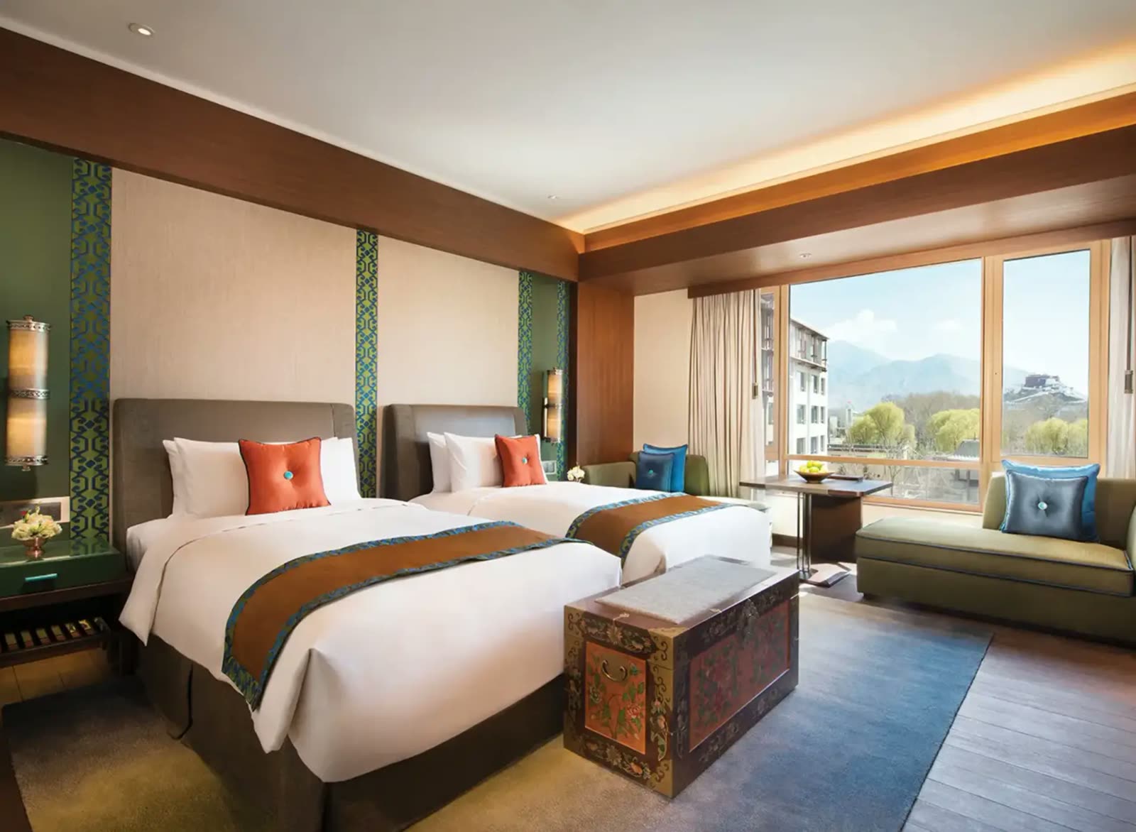 Twin guest room with Tibetan textiles and a window onto the Potala Palace