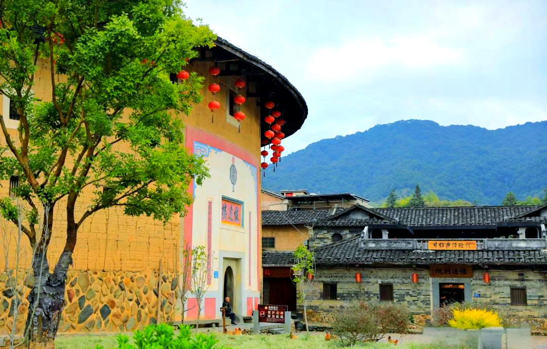 The earthen walls and lanterns of a tulou entrance, Yongding