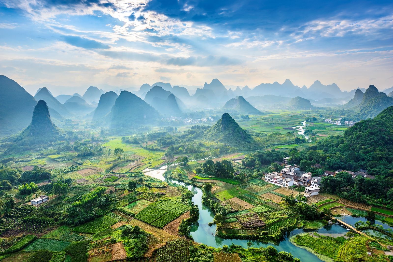 Aerial view of karst peaks and a winding river near Guilin at sunrise
