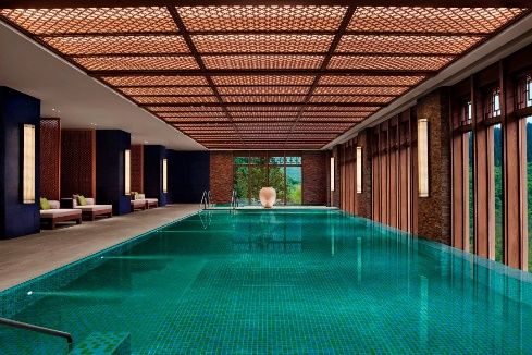 Indoor pool with patterned ceiling at Rissai Valley, a Ritz-Carlton Reserve