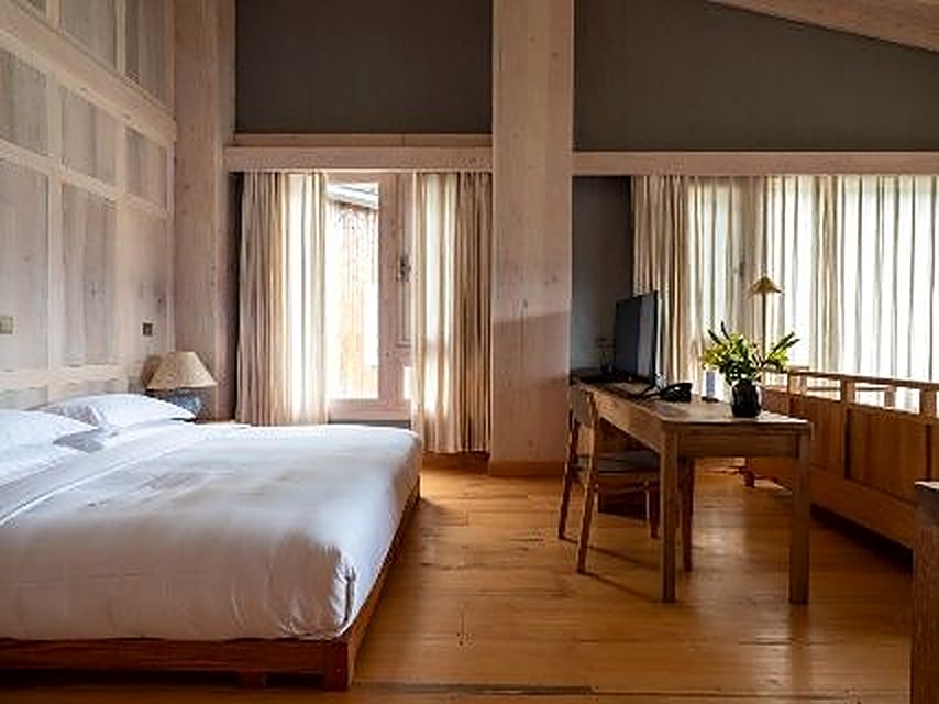 Room interior with wood beams at Songtsam Linka Bome