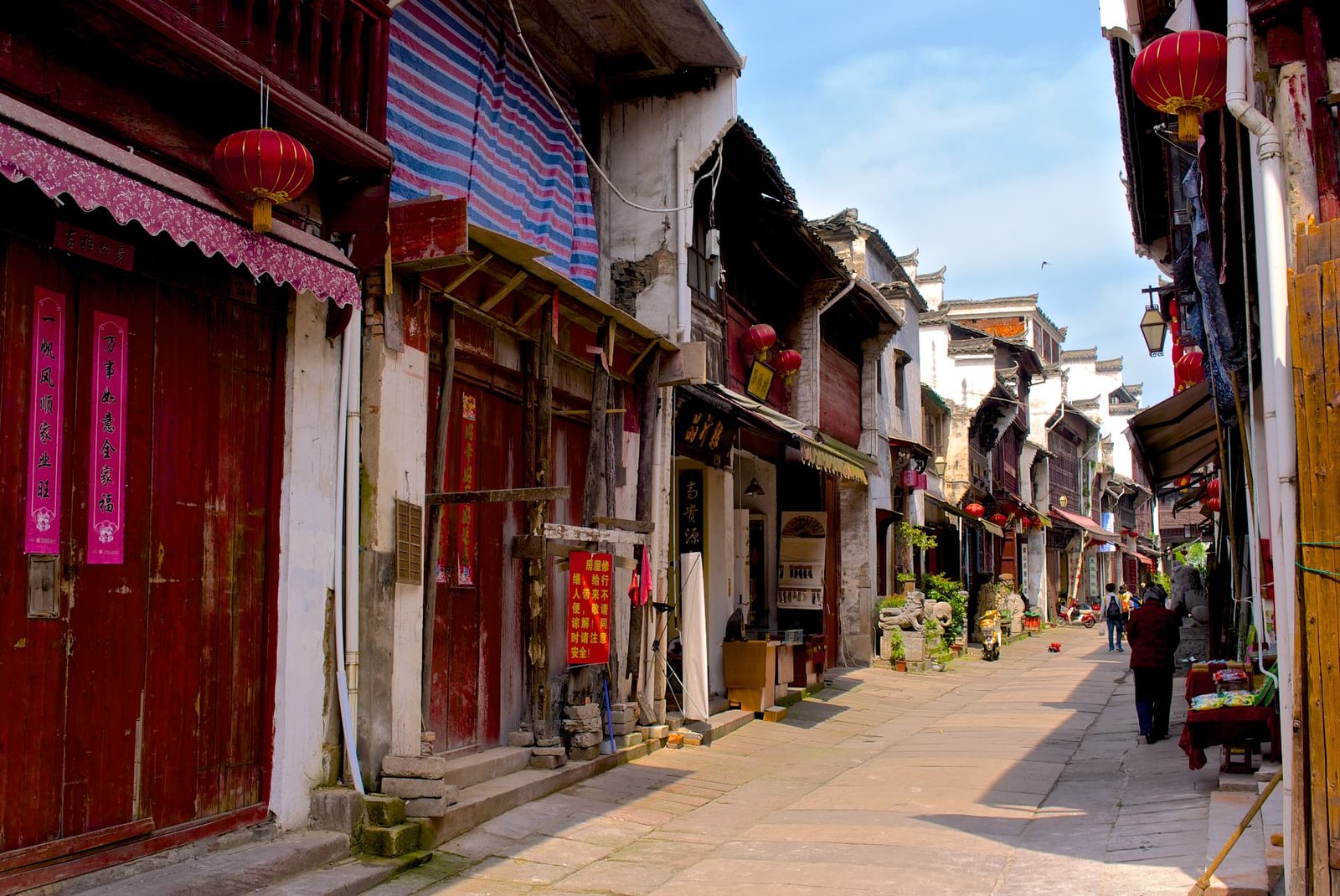 Red lanterns above the stone-paved shopfronts of Tunxi Old Street