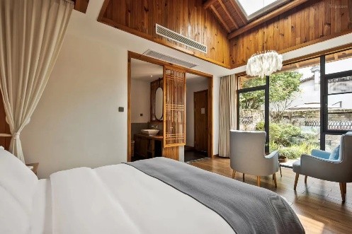 A timber-beamed guestroom at Yun Ji Boutique Homestay