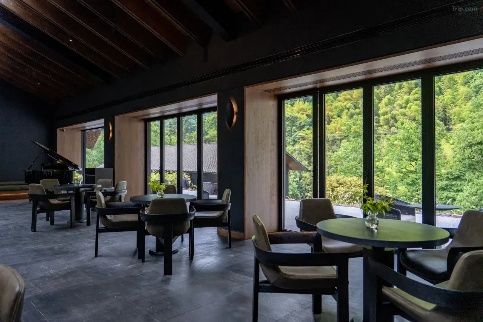 Lounge with floor-to-ceiling windows onto greenery at Lanyu ZOLAND Hotel