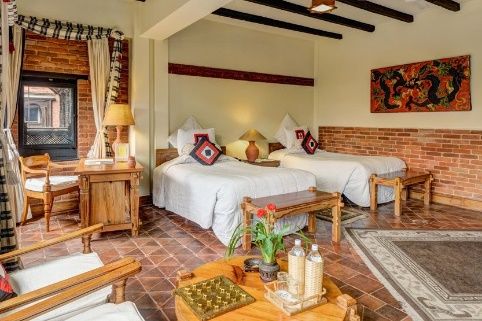 Traditional twin room with carved woodwork at Dwarika's Hotel