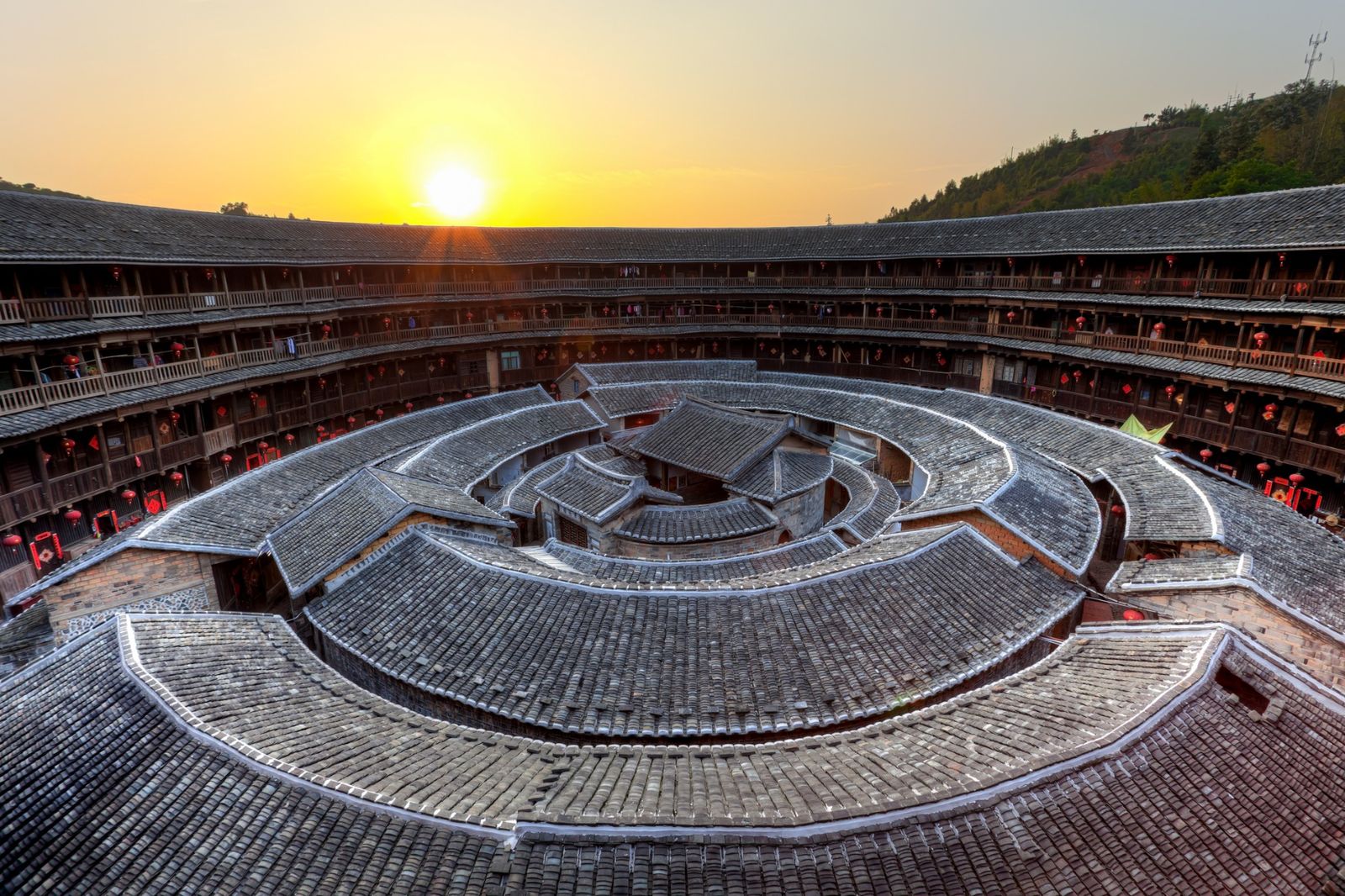 Aerial view of circular Fujian tulou buildings at sunset