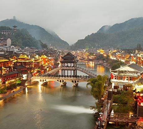 Fenghuang Ancient Town lit at night along the Tuo River