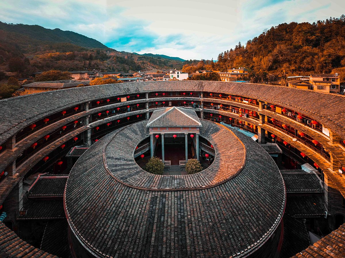 A circular tulou hung with red lanterns, seen from above