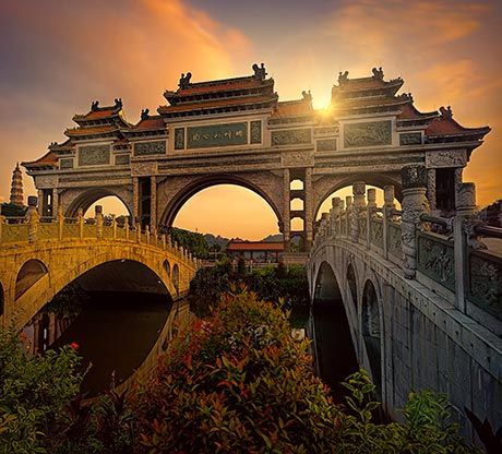 Ancient stone bridges and archway at sunset in Shunde