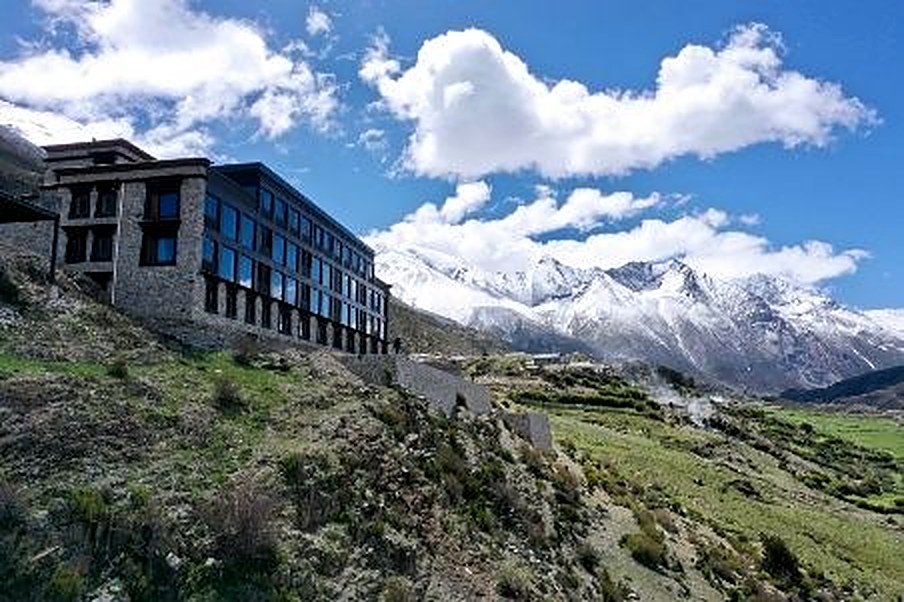 Songtsam Lodge Laigu set against snow-covered mountains