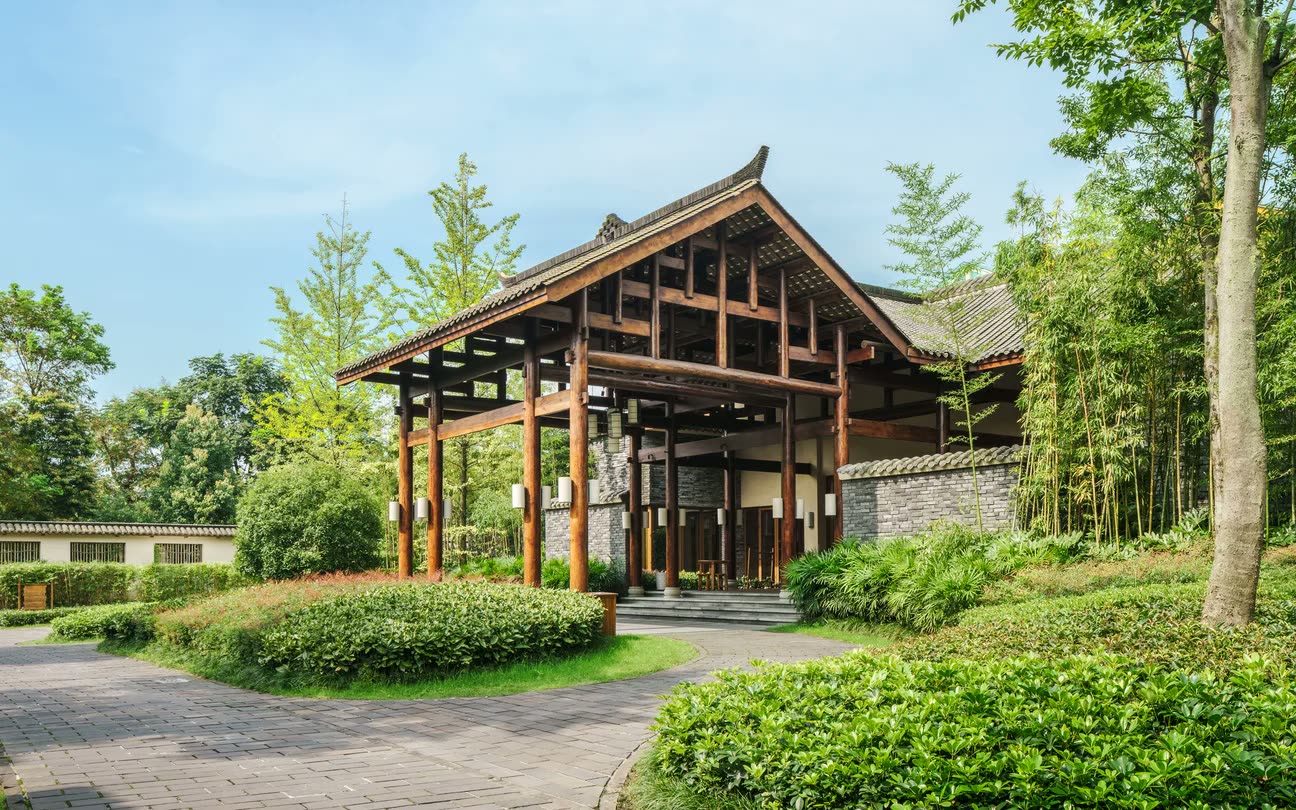 Timber and gray-brick entrance pavilion at Six Senses Qingcheng Mountain