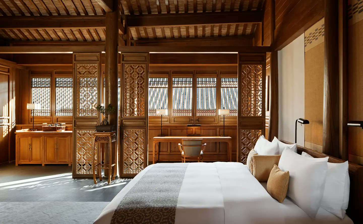 Timber-panelled courtyard suite interior at Amandayan, Lijiang