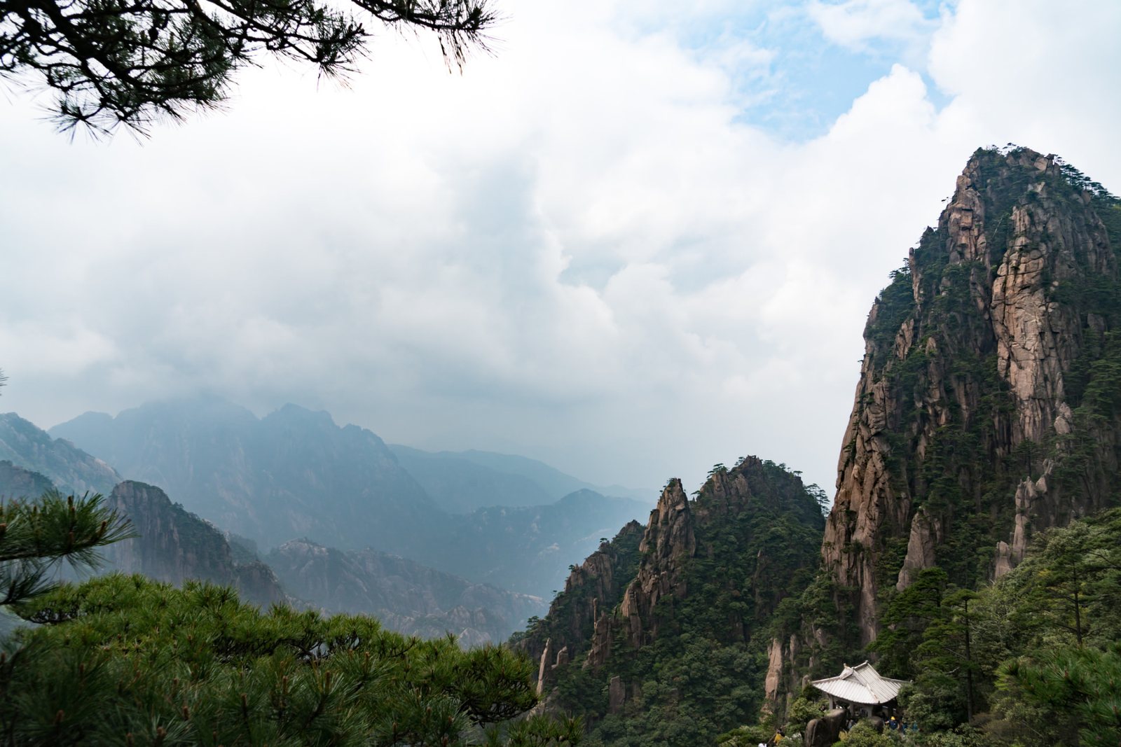 Pine-framed granite peaks and a summit pavilion on Huangshan