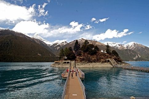 Pilgrims crossing a footbridge to the island on Basong Tso lake