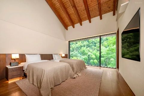 Guest room with timber ceiling and forest view at Lanyu ZOLAND Hotel