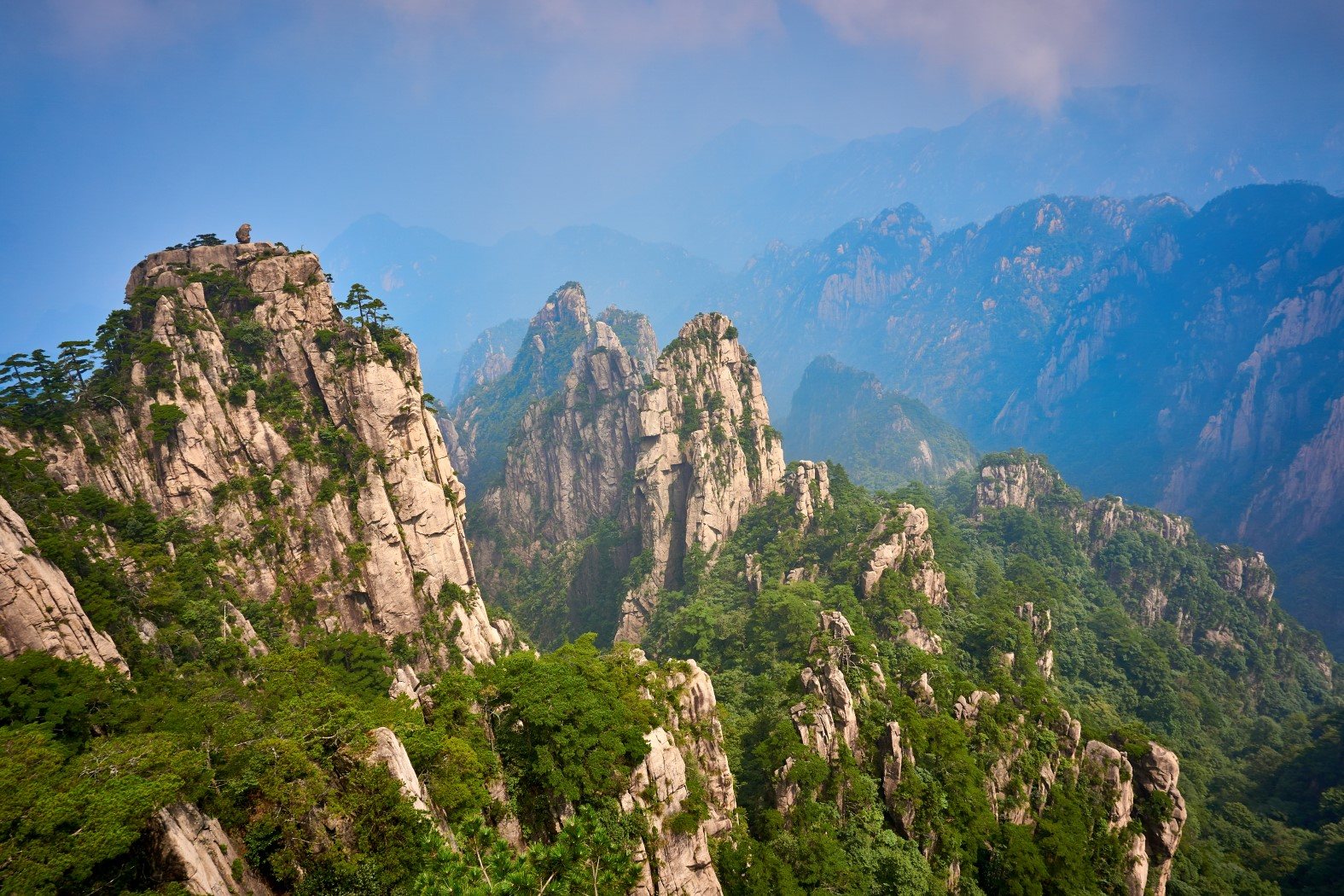 Sunlit granite spires of Huangshan above a sea of haze