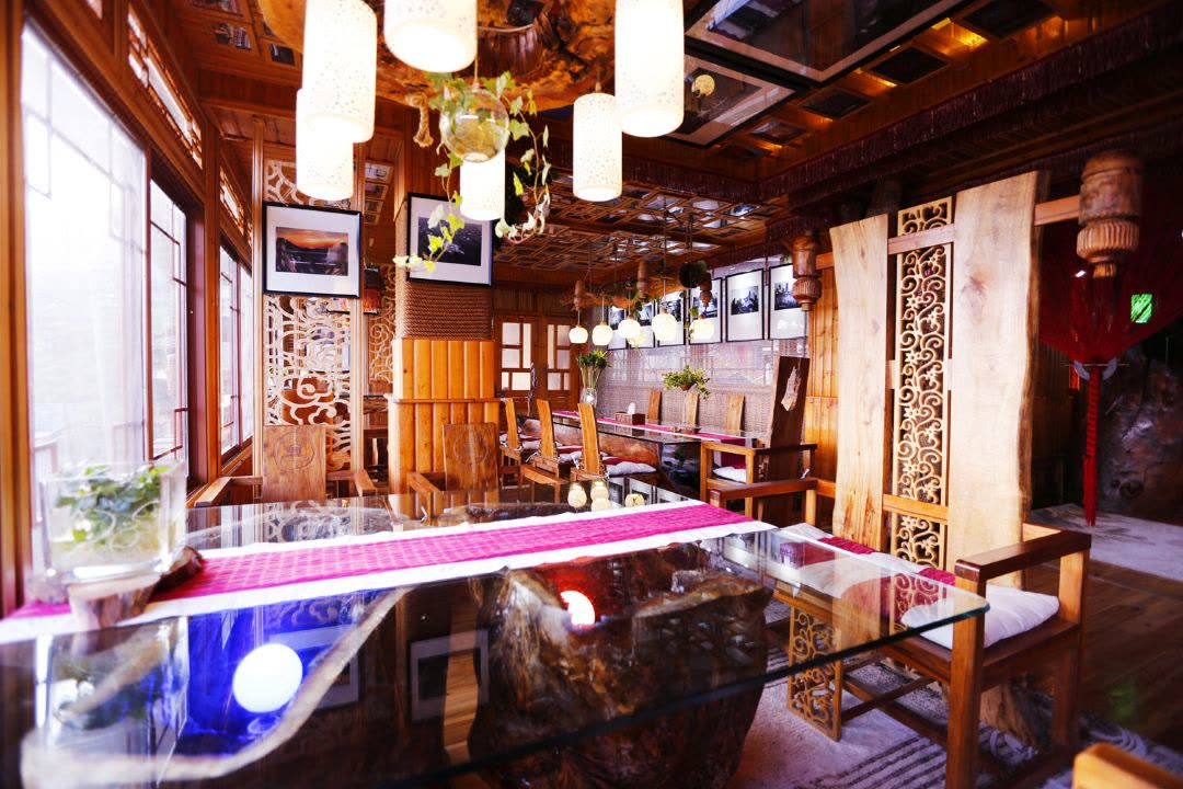 Timber-panelled restaurant at Longji One Art with lanterns and local carvings
