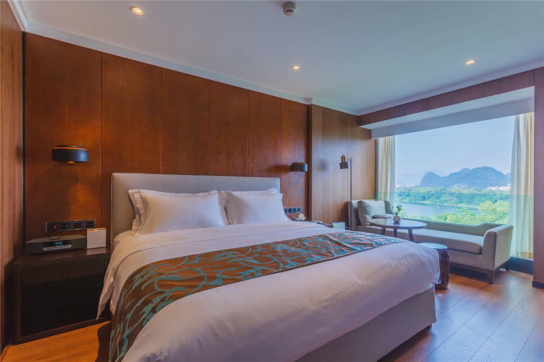 Club River View room at Jolie Vue with karst peaks framed by the window