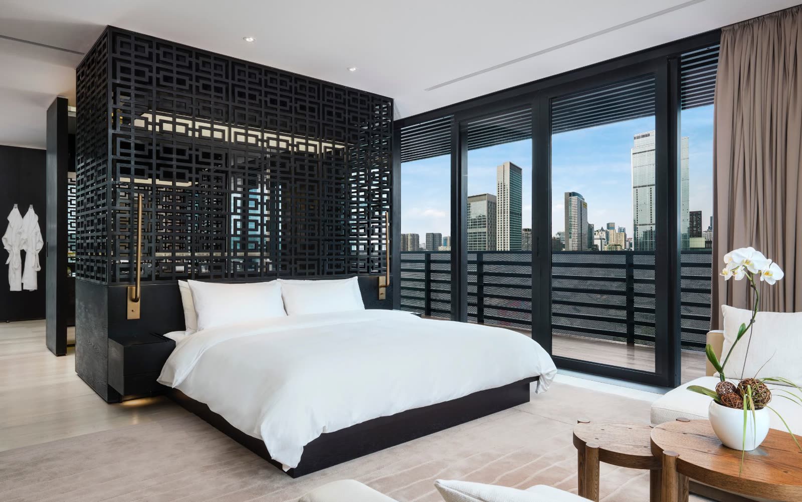 Studio guest room with latticed screen and city view at The Upper House