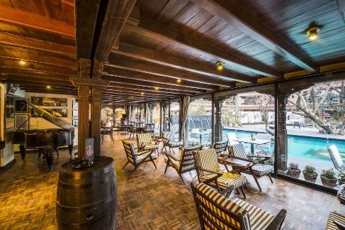 Poolside lounge with wooden beams at Dwarika's Hotel, Kathmandu